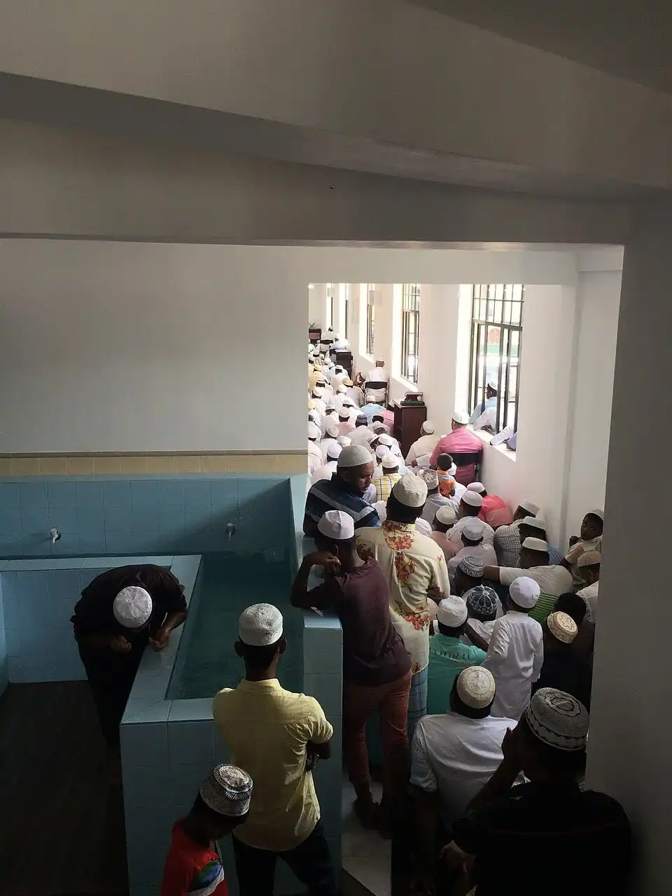 People sitting in Wudu area due to overflow