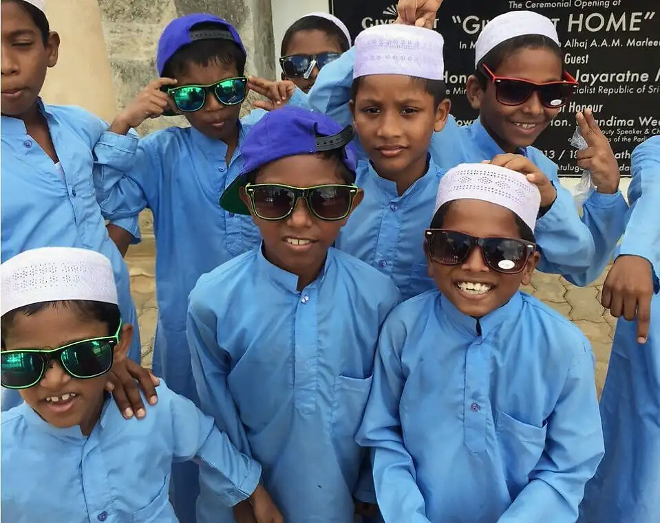 Children from Give Light Home in blue kurtas and sunglasses