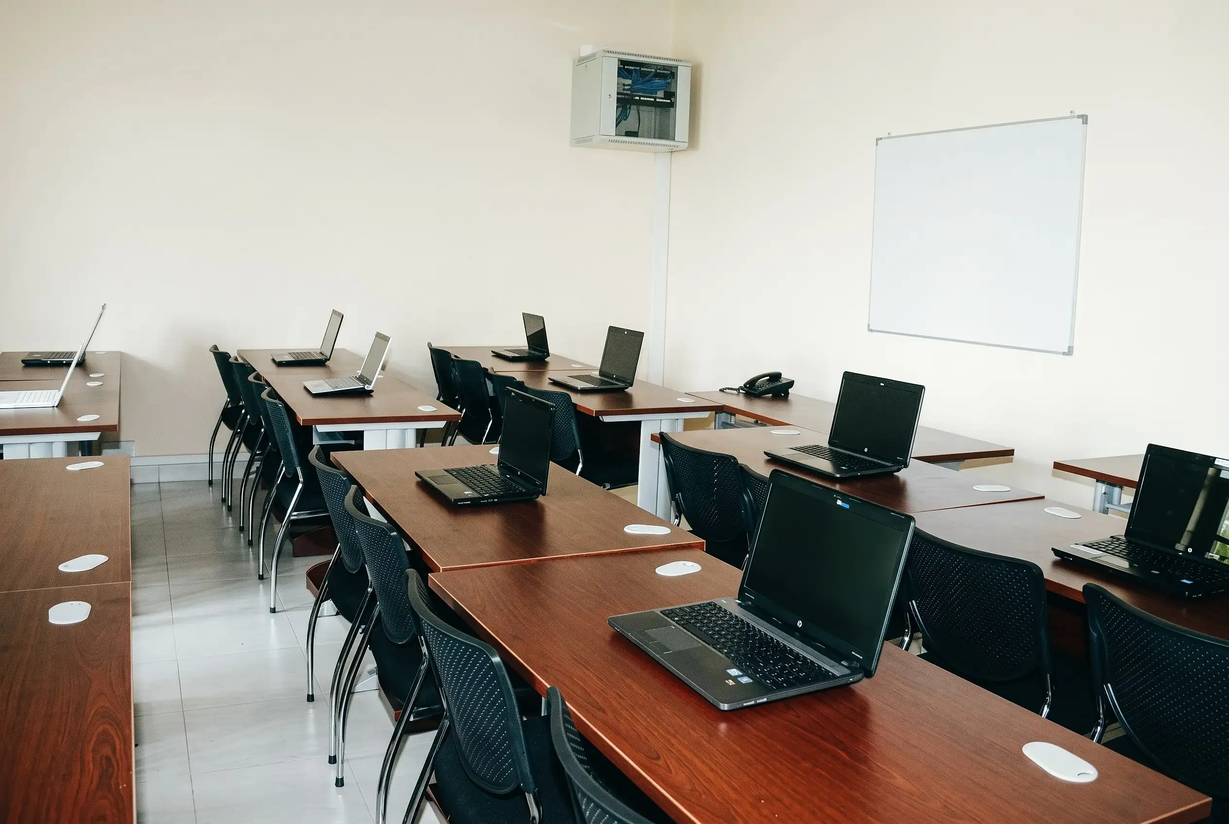 The computer lab of the Vocational Training Center, with laptops on rows of desks